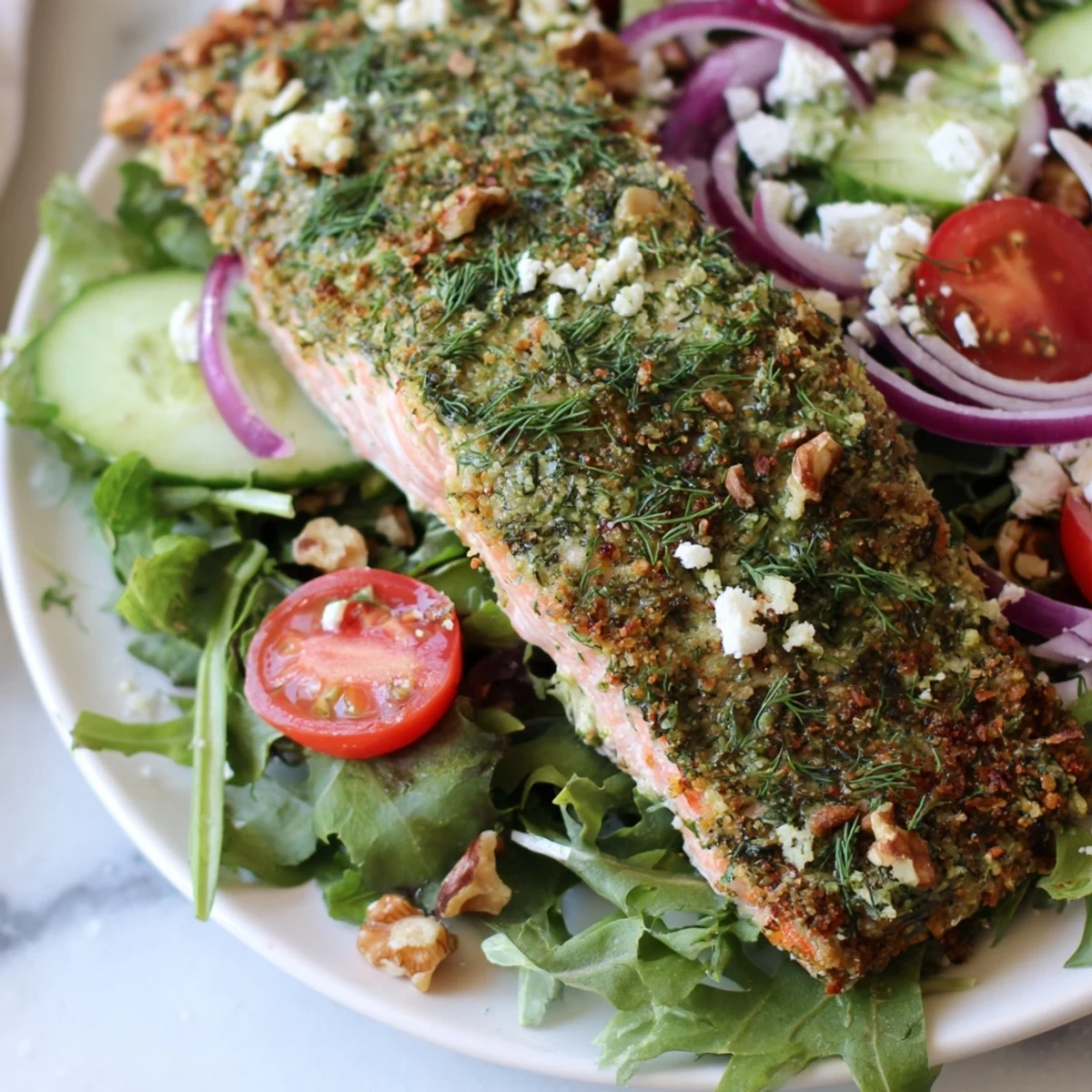 A plate of delicious herb-crusted salmon salad, with tender salmon and a bright vinaigrette.
