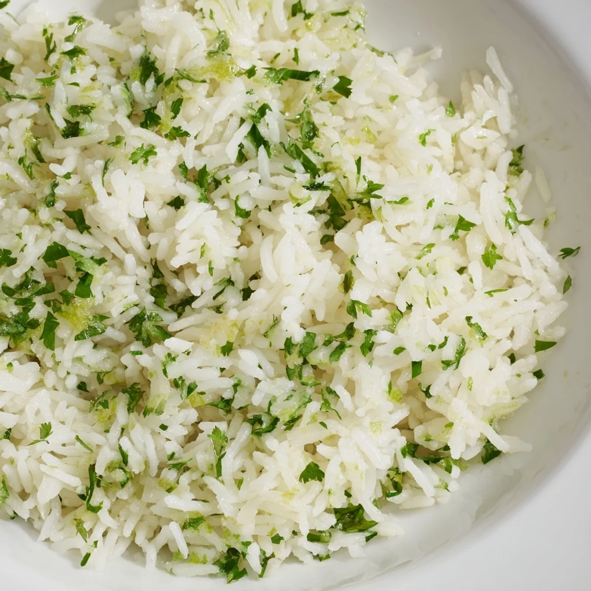 A vibrant bowl of cilantro lime rice, visually appealing with bright green cilantro flecks, ready to eat.