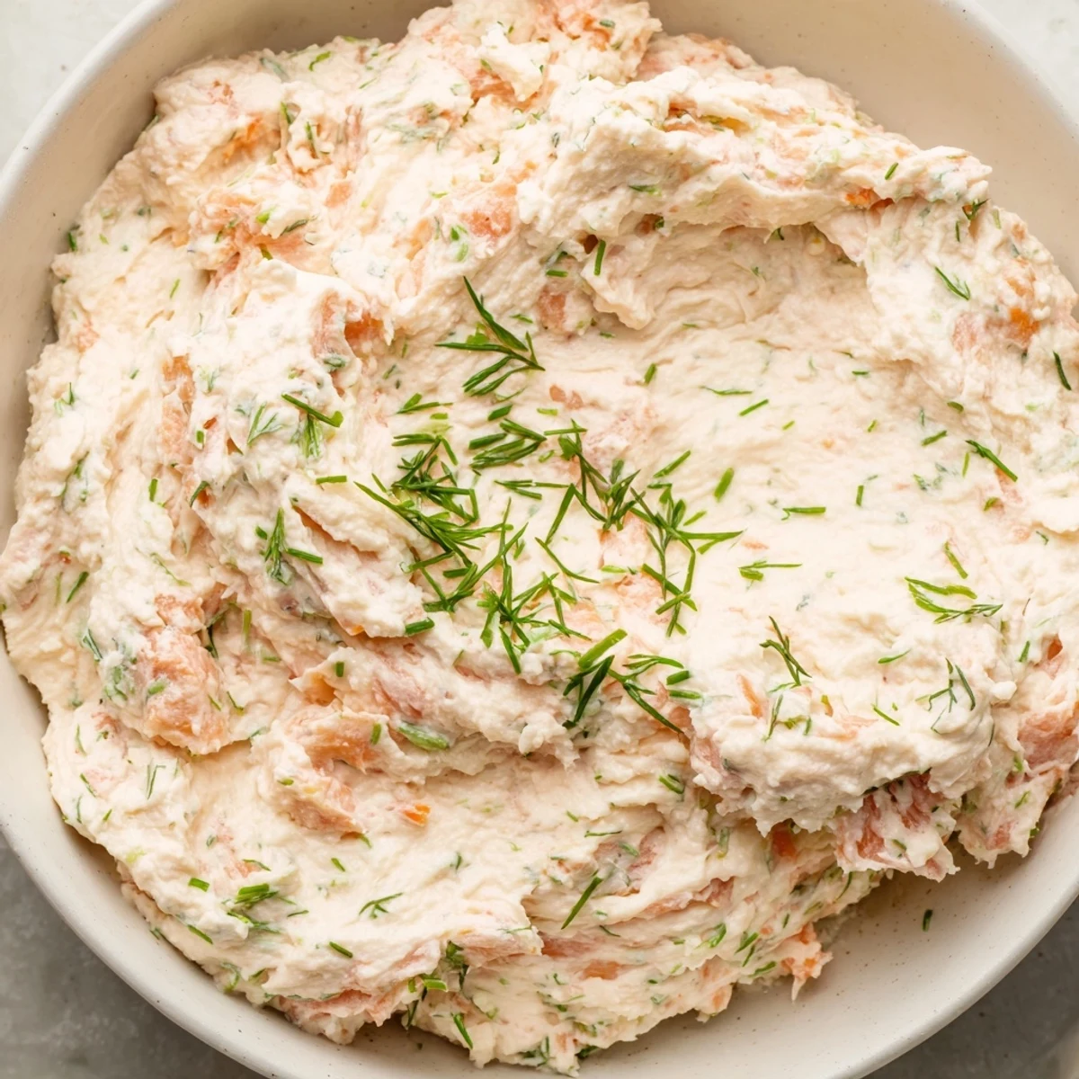 A close-up of the easy smoked salmon dip, featuring flaked salmon and bright herbs, perfect for appetizer spreads.