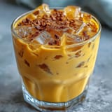 Refreshing Turmeric Golden Milk Iced Latte on ice, perfect for a vibrant afternoon treat.
