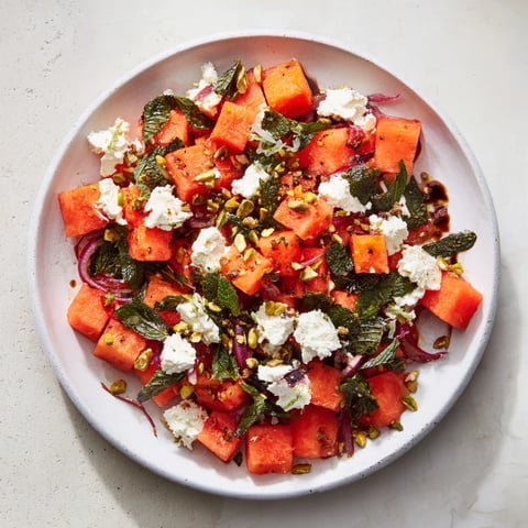 Juicy watermelon and creamy feta combine in this refreshing Fresh Watermelon and Feta Salad, drizzled with glaze.