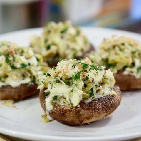 Creamy Spinach and Artichoke Stuffed Mushrooms, golden brown, bubbling with cheese, ready to eat!