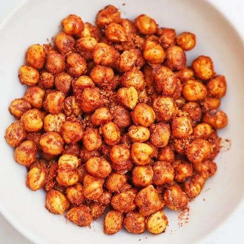 Freshly roasted crispy chickpea snacks tossed with a bold spice blend, perfect for vegan snacking.  