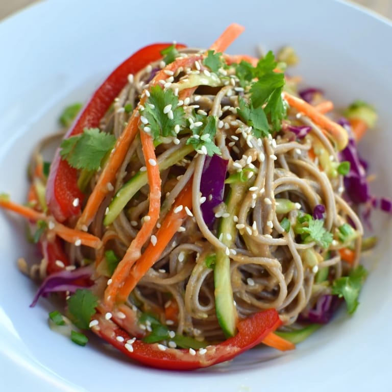 Cold and delicious Japanese-inspired soba noodle salad, showcasing tender noodles and crunchy vegetables.