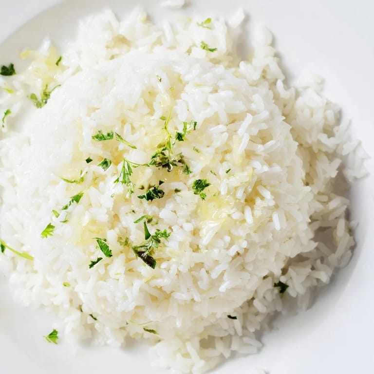 Close-up of freshly made Garlic Butter Rice, the garlic-infused grains glistening with melted butter.