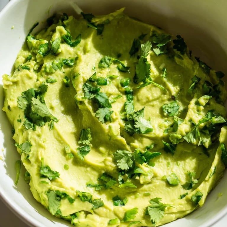 Homemade Mexican-inspired avocado lime dip ready for dipping chips, spreading on sandwiches, or topping tacos.