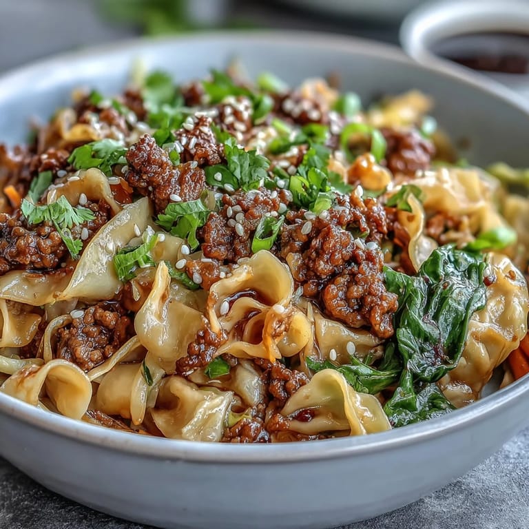 Comforting Potsticker Noodle Bowls served with golden pork, crunchy carrots, and bean sprouts, garnished with sesame seeds and fresh cilantro leaves.