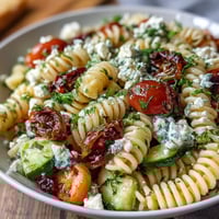Vibrant Lemon Vinaigrette Pasta Salad with crisp cucumbers and juicy cherry tomatoes in a tangy lemon dressing.  