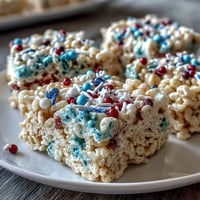 Festive 4th of July Rice Krispies treats with red, white, and blue layers, perfect for Independence Day parties.  