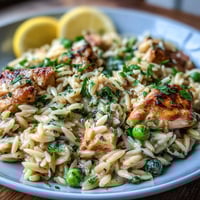 Creamy One-Pot Lemon Orzo with tender chicken and sweet peas, bursting with fresh lemon flavor in a comforting single-pan meal.