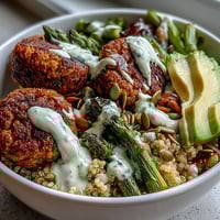 Vibrant Spring Buddha Bowl with crisp falafel and creamy lemon tahini.